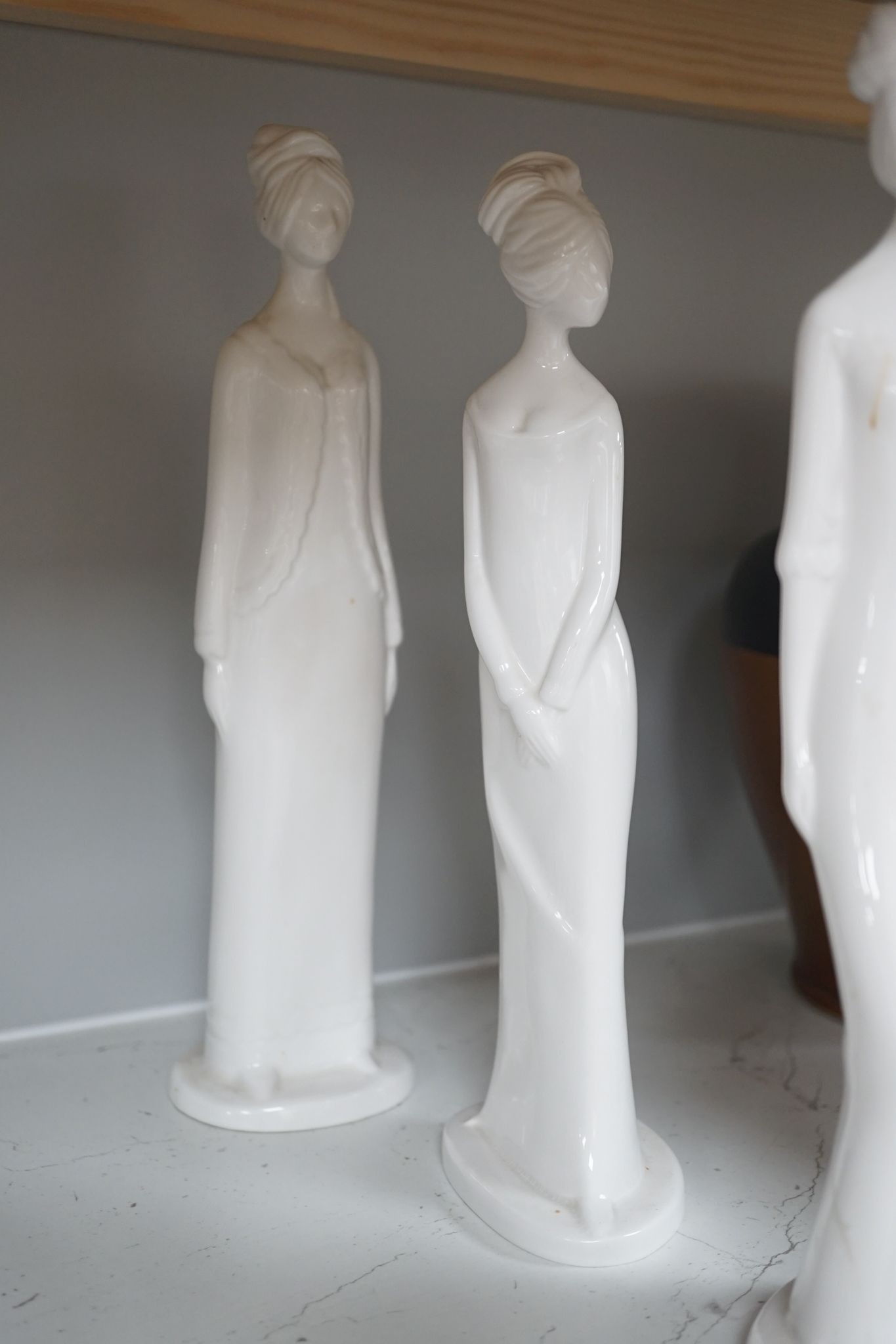 Eight Spode white glazed porcelain figures of elegant ladies by Pauline Shone 27cm